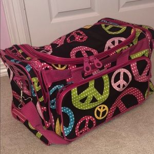 Multicolored duffle bag with peace signs